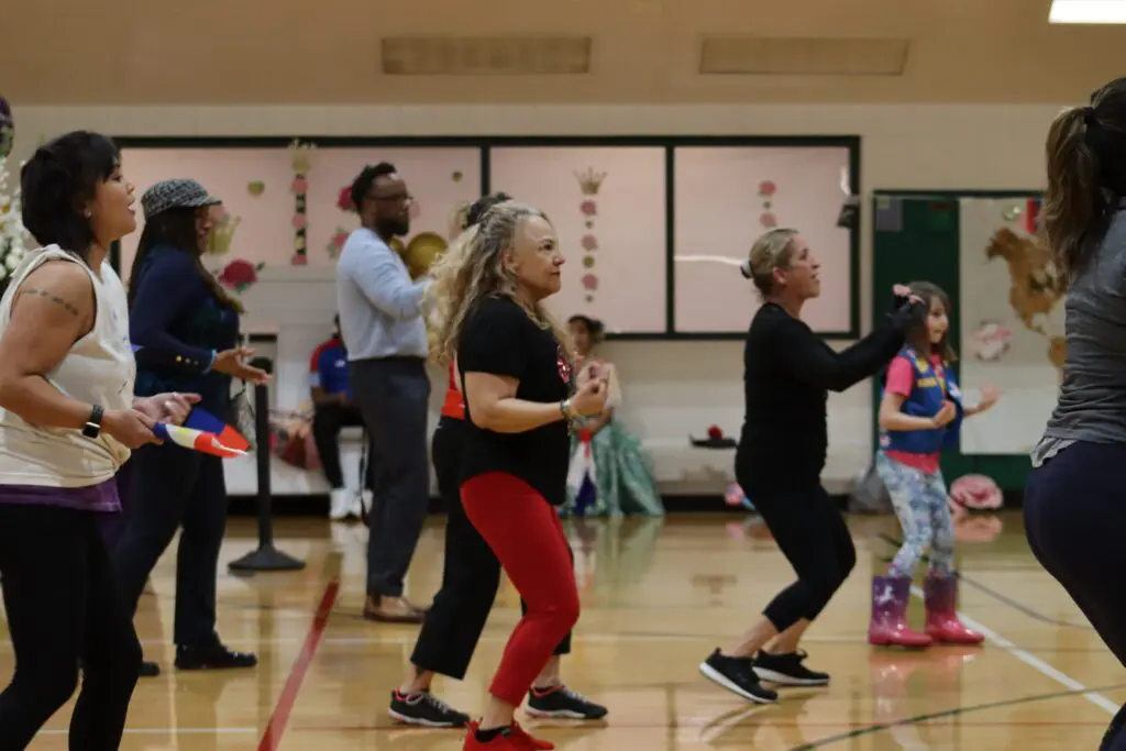 a group of people dancing in a gym